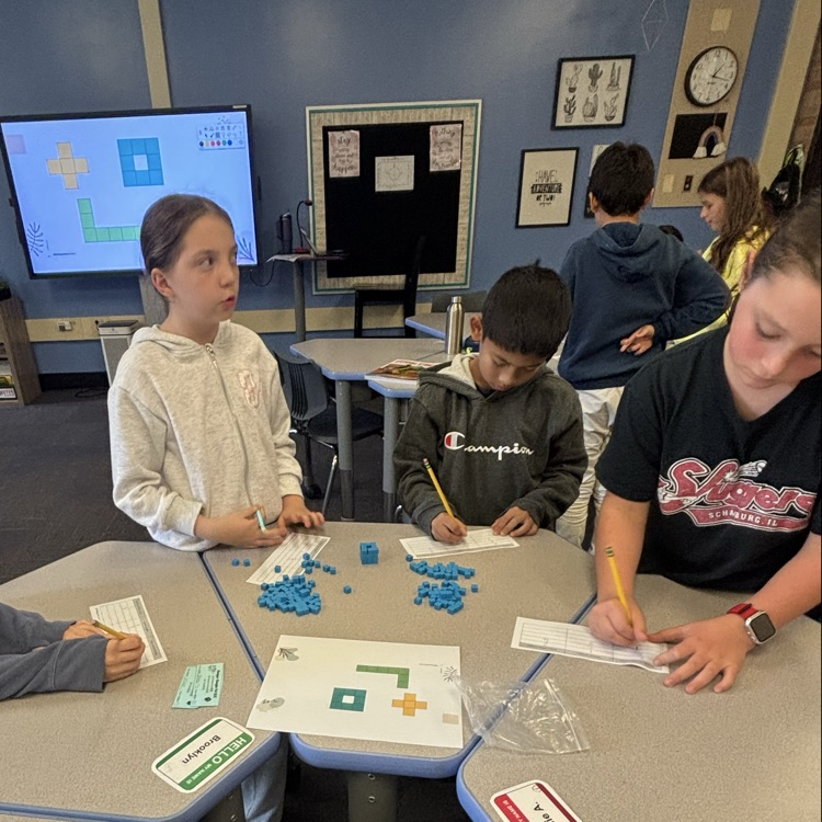 students recording information from the exploration of area with base 10 blocks  