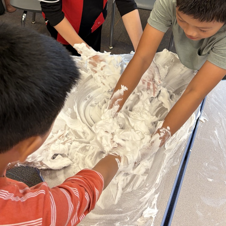 students playing with shaving cream on their desks