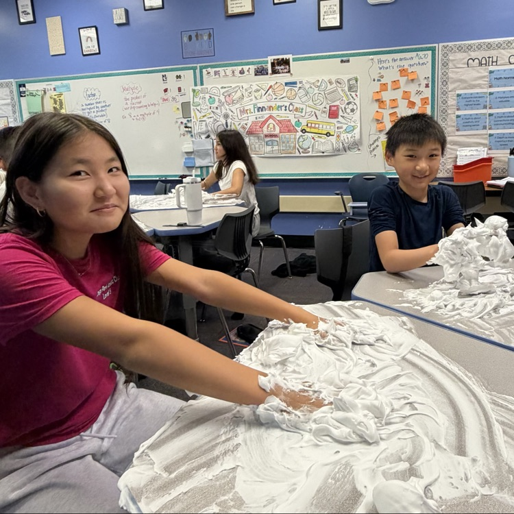 students playing with shaving cream on their desks