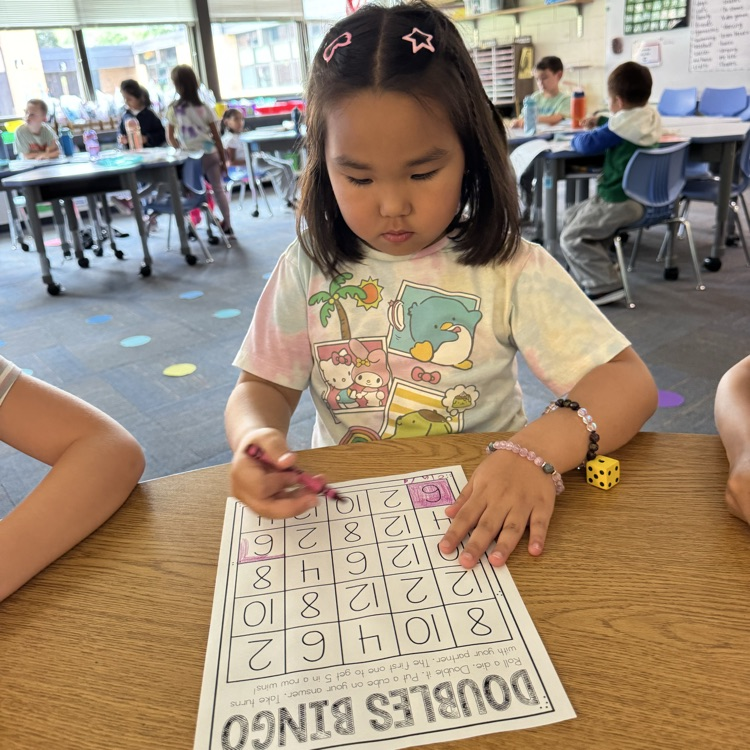 student working on a doubles worksheet 