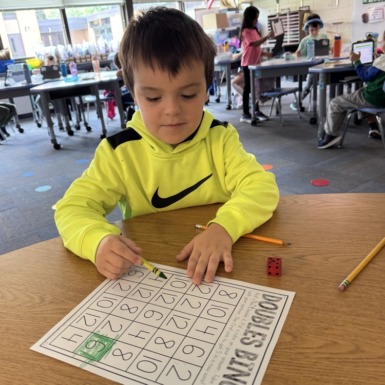student working on a doubles worksheet 