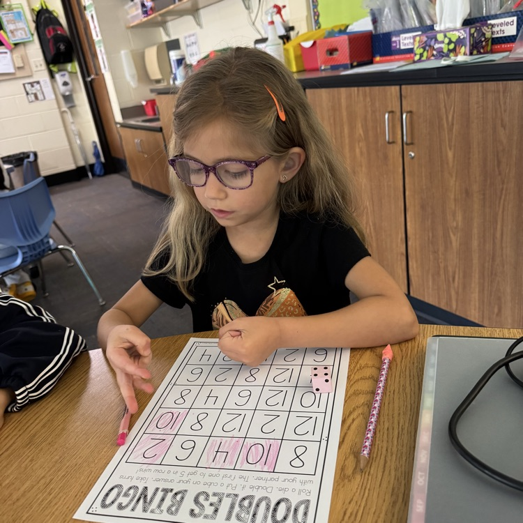 student working on a doubles worksheet 