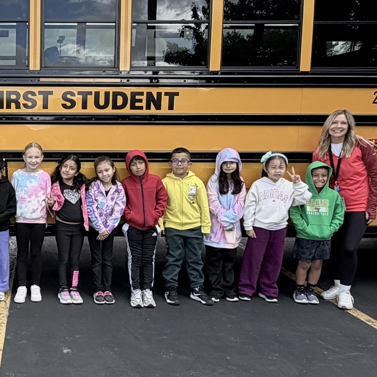 Mrs. Ernsting and her class in front of the bus.
