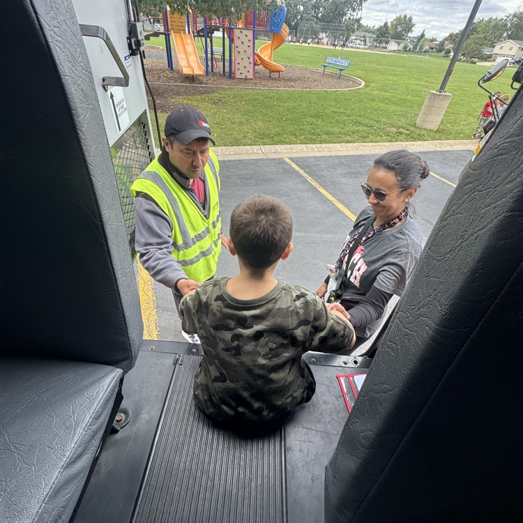 Student practicing getting off the bus. 