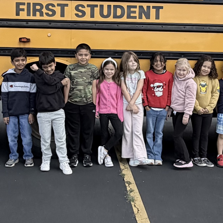 Second graders in front of the bus. 