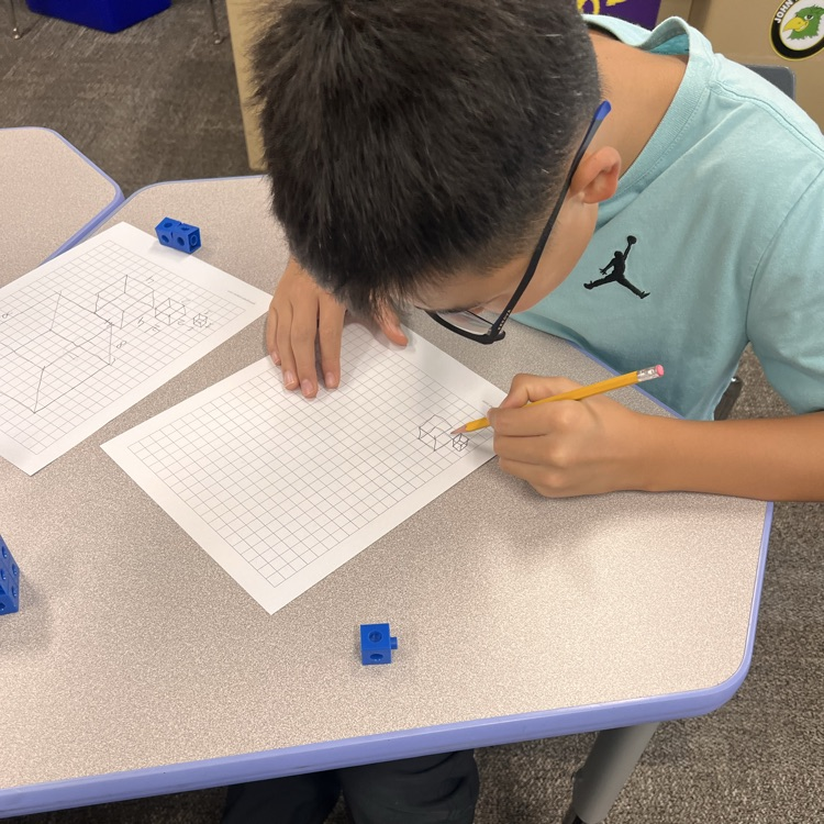 student working on grid paper
