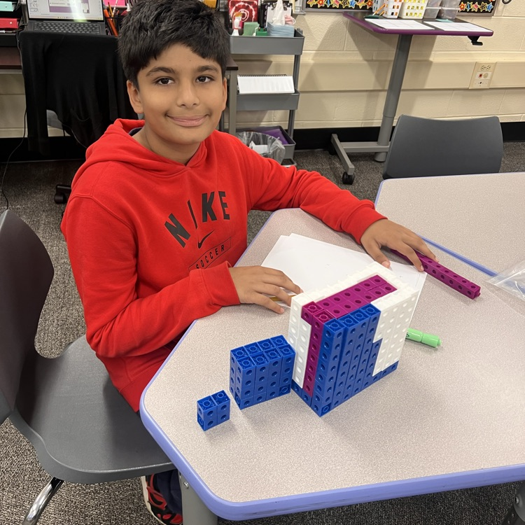 student working with different sized rectangular prisms