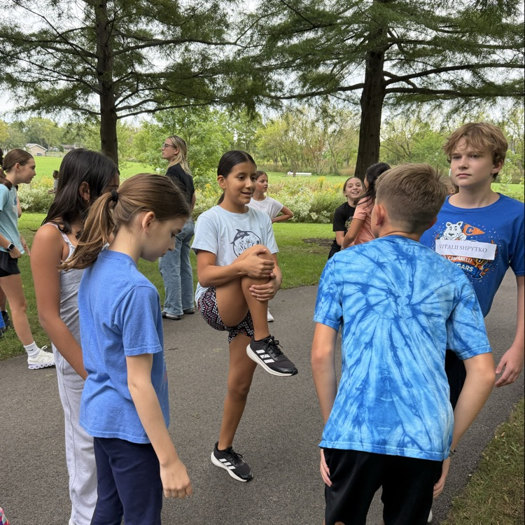 Photo of 6th Grade students talking in a group