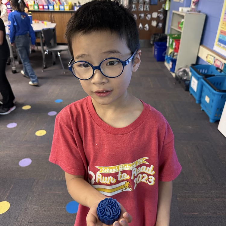 student holding a Play-Doh mooncake