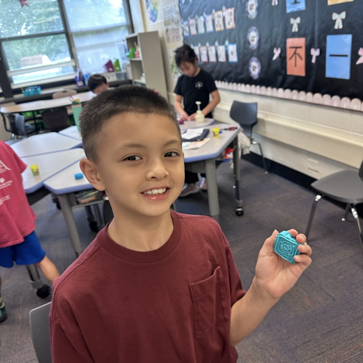 student holding a Play-Doh mooncake