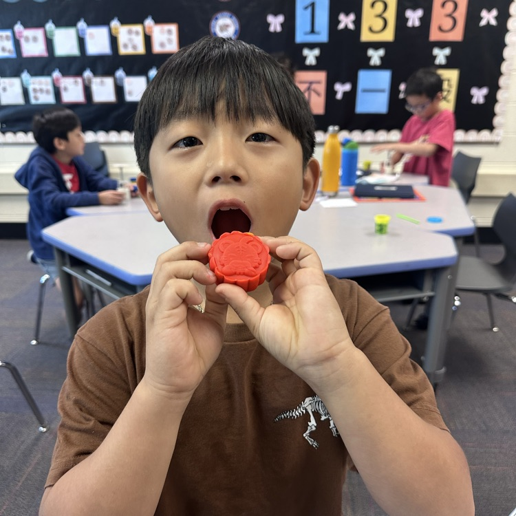 student pretending to eat a Play-Doh mooncake 