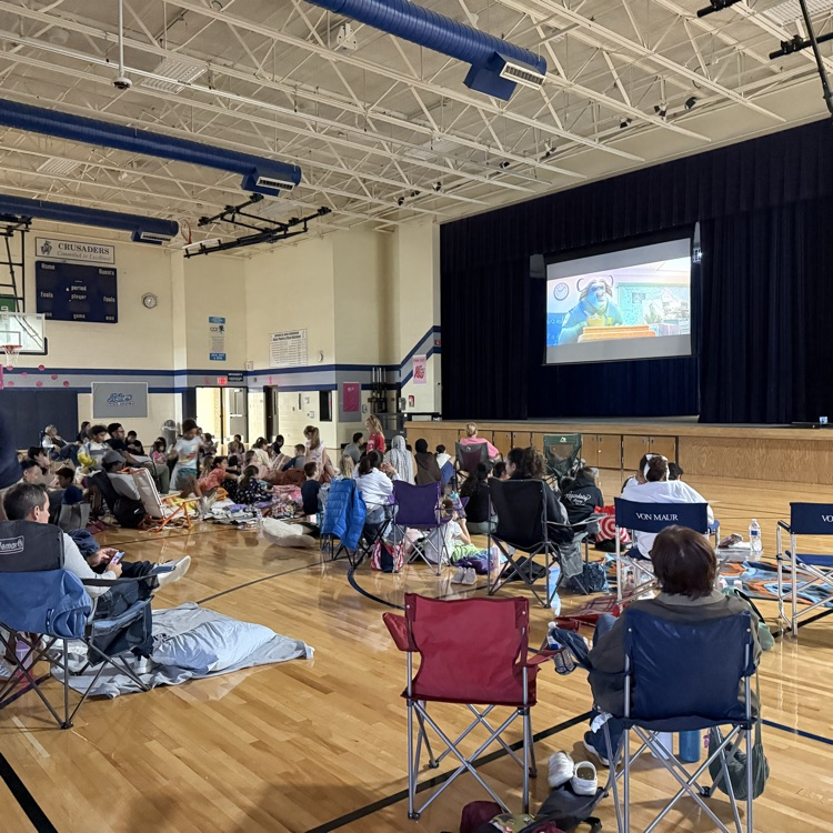 people sitting in gym watching movie 