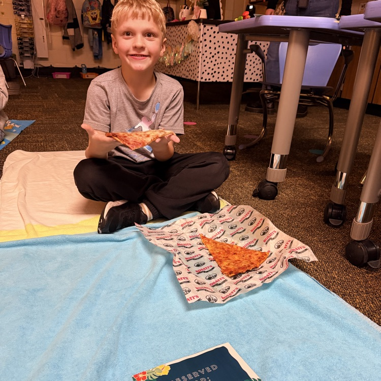 Student eating lunch on a beach towel