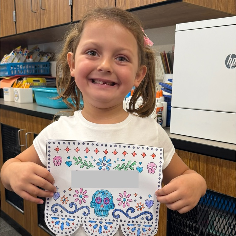 student holding artwork