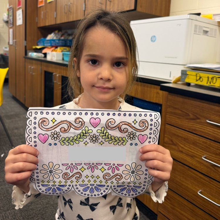 student holding artwork