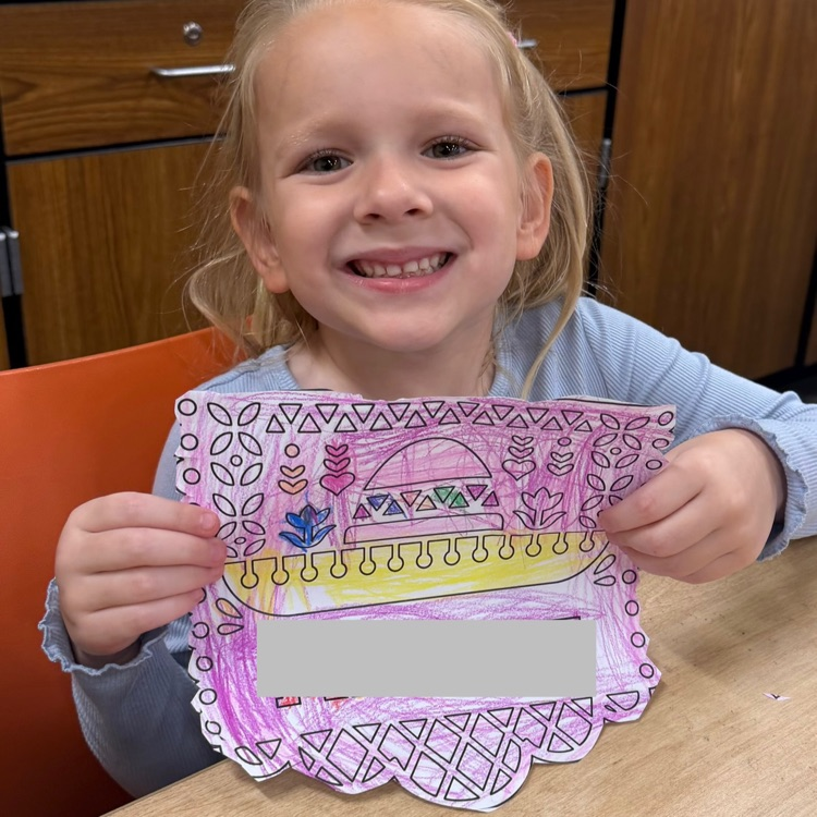 student holding artwork
