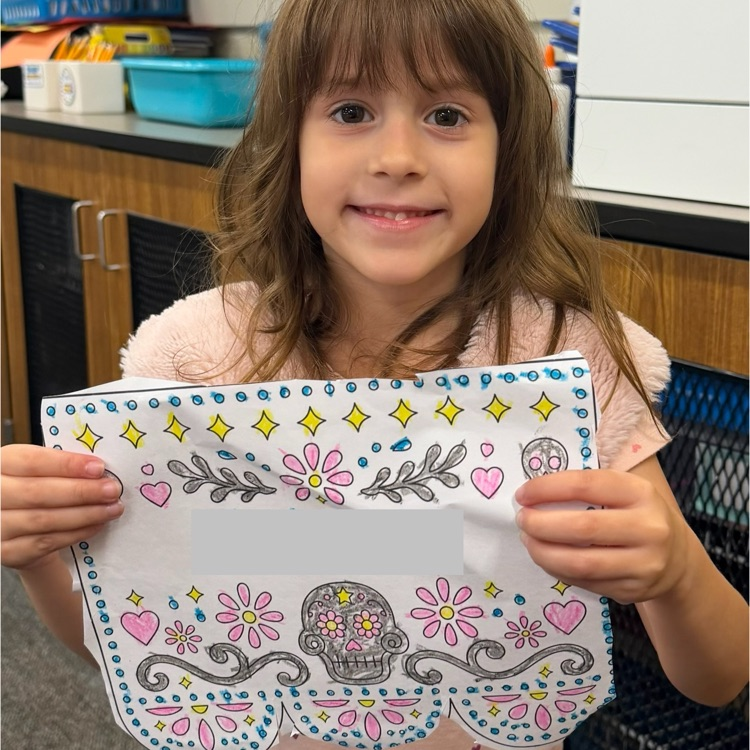 student holding artwork
