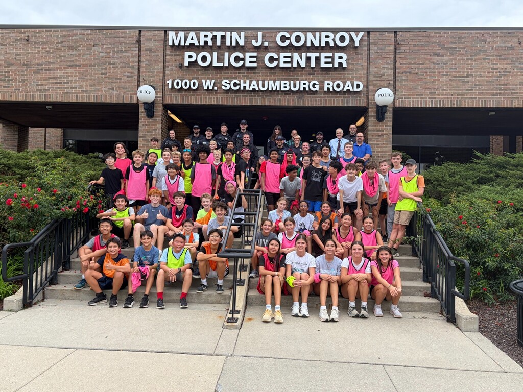 students posing outside of the police station