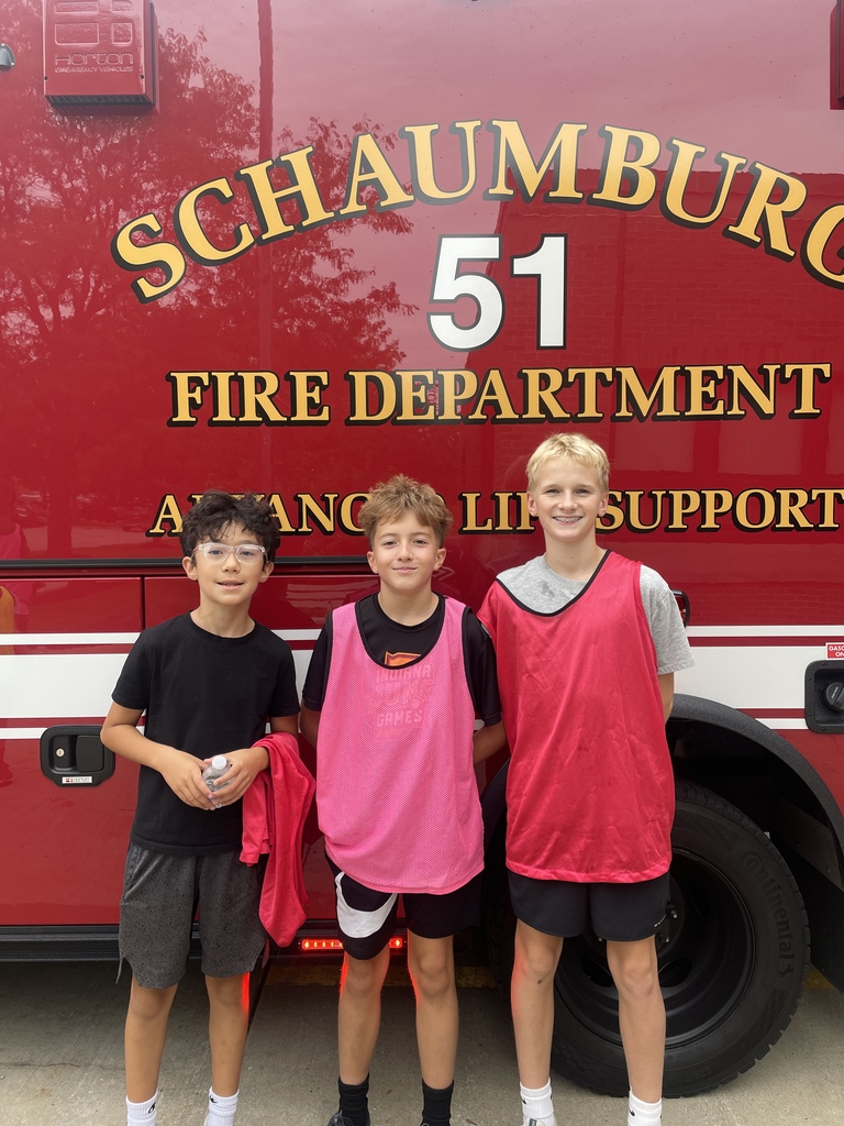Students posing with a fire truck