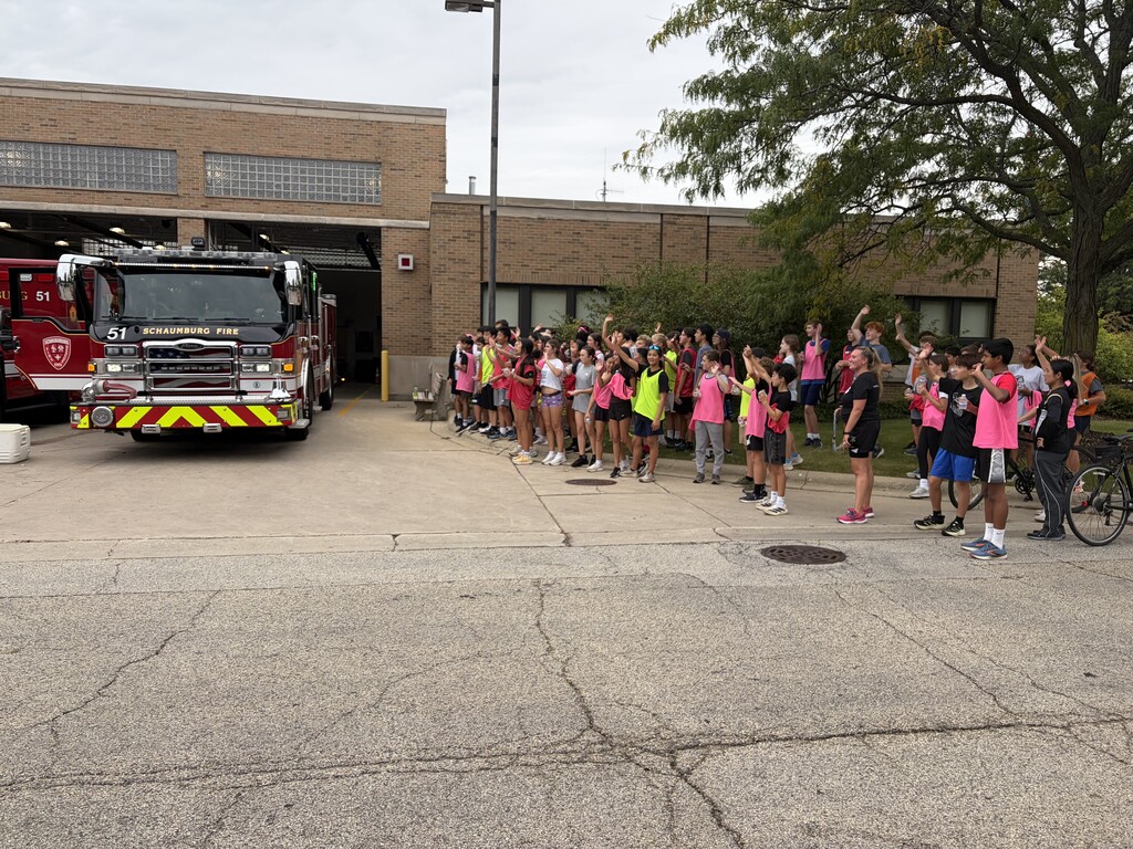 students posing outside a fire station