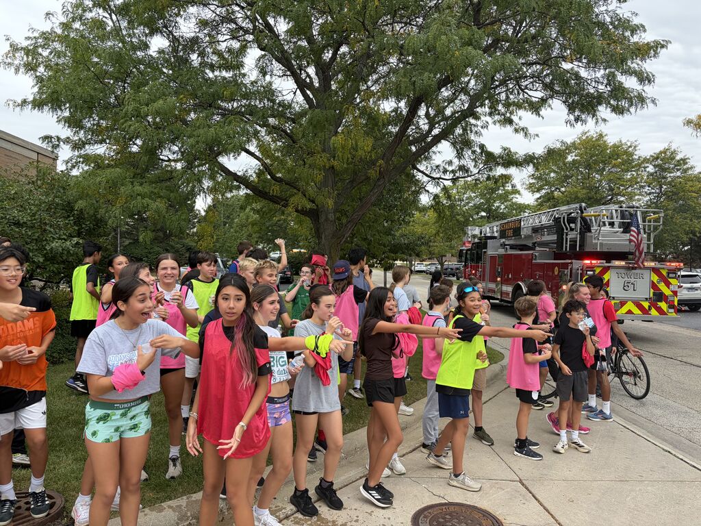 students posing outside a fire station