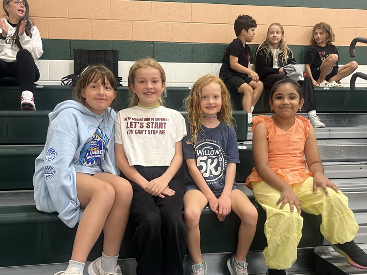 students in stands at basketball game
