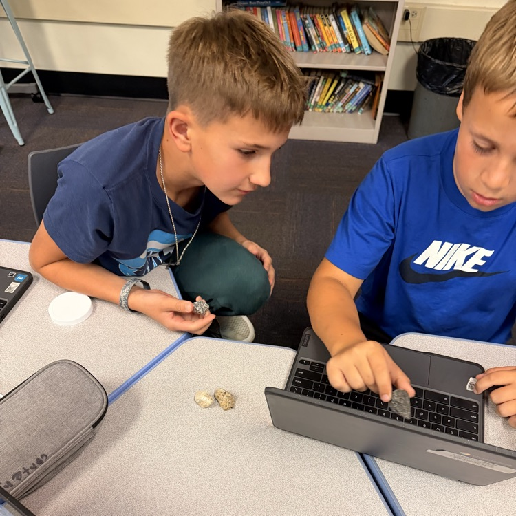 students look at rocks 
