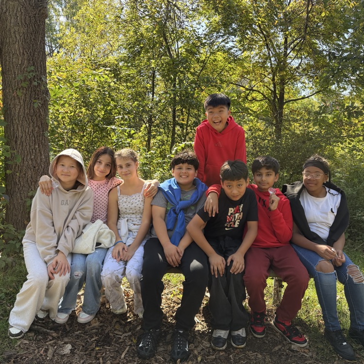 group of students sitting on a bench