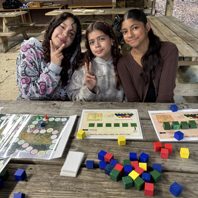 students with learning tools at a picnic table