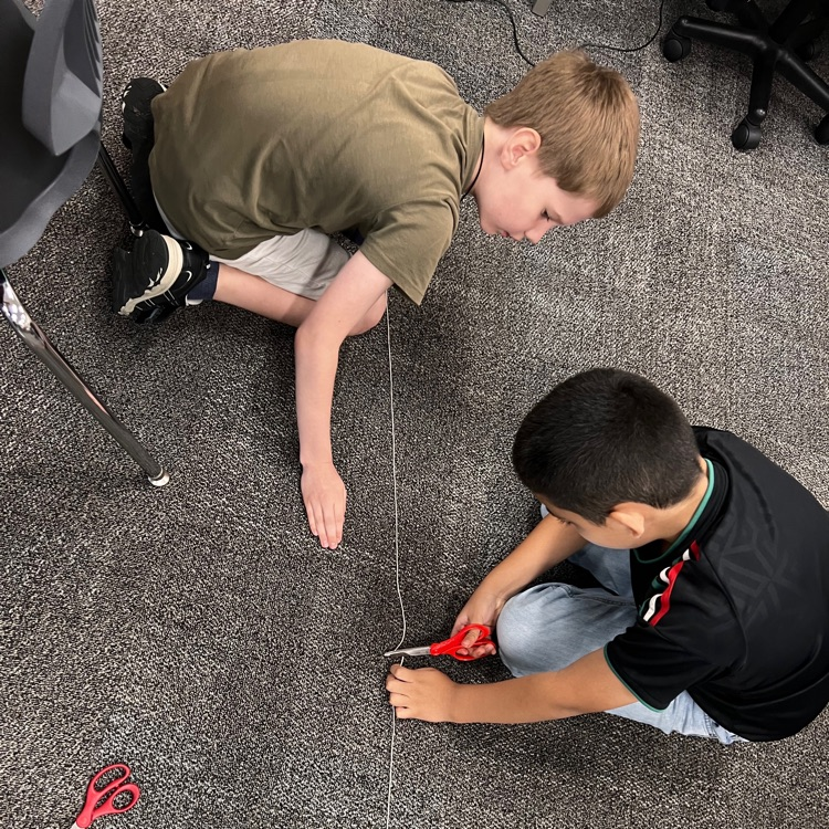 students measuring with string