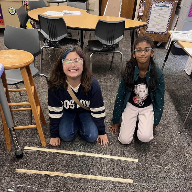 students comparing their string to a ruler