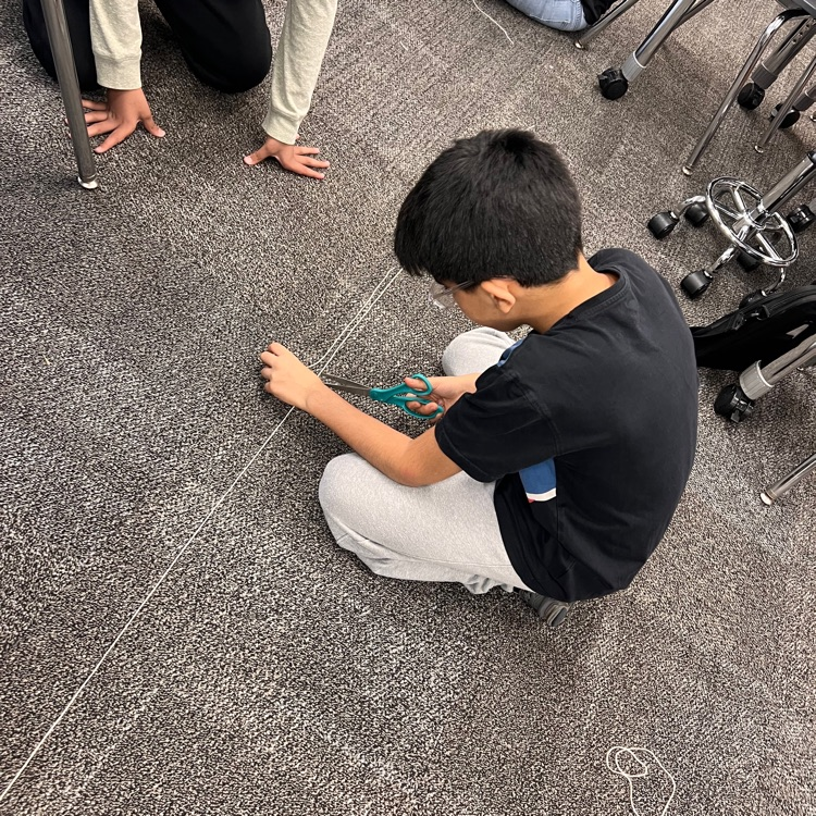 student cutting string