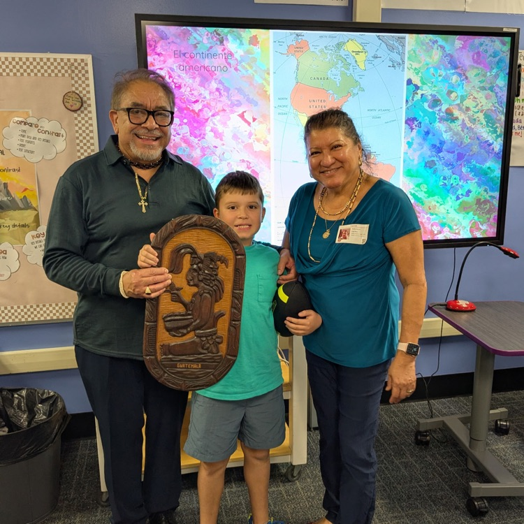 A 3rd grader and his family after their presentation on Guatemala.