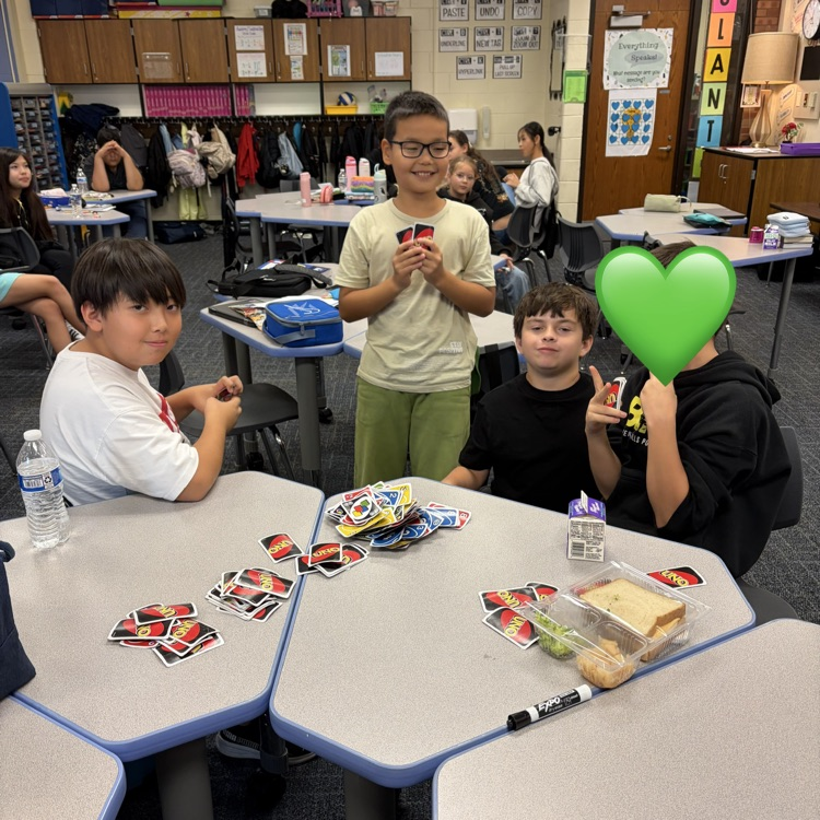 Group of boys playing uno during indoor recess.