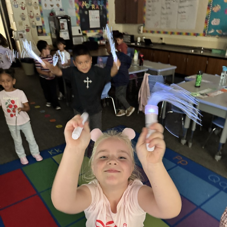 students dancing with glow sticks