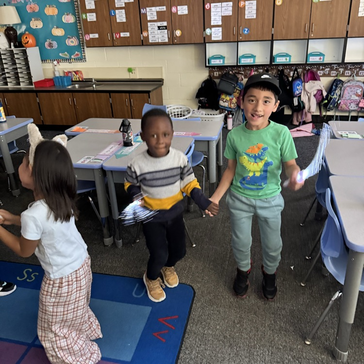 students dancing with glow sticks