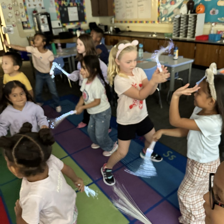 students dancing with glow sticks