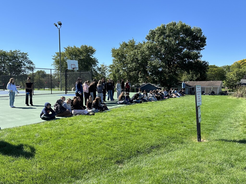 Students listen to a scientific demonstration of a self-carving pumpkin