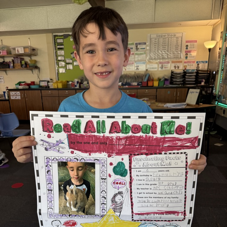 student holding up their star of the week poster 
