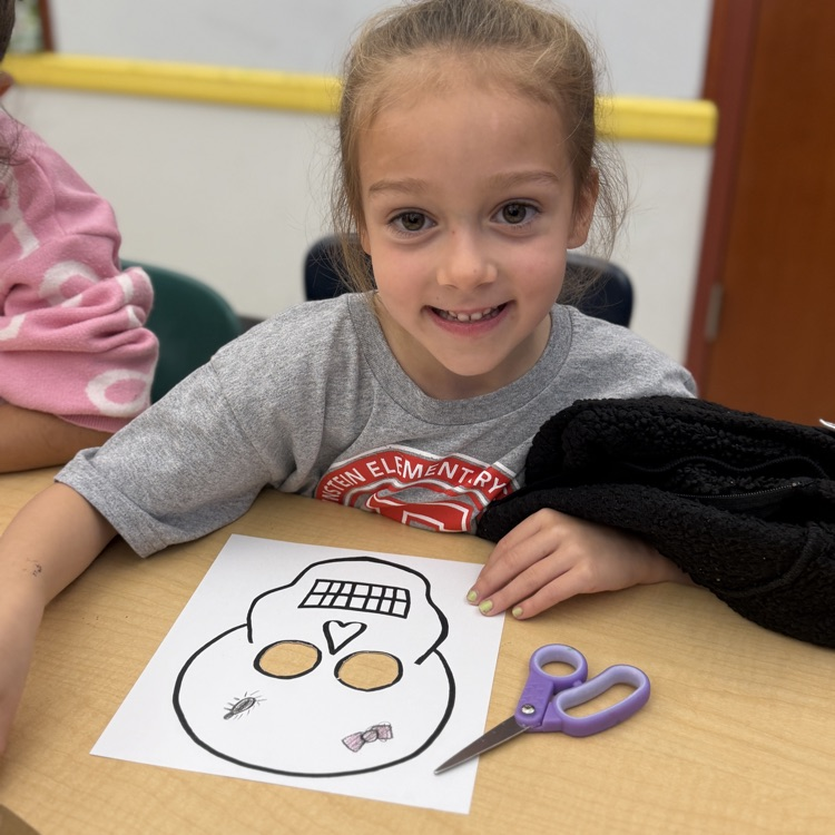 First grader making skull mask