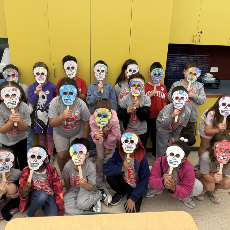 Students posing with skull masks