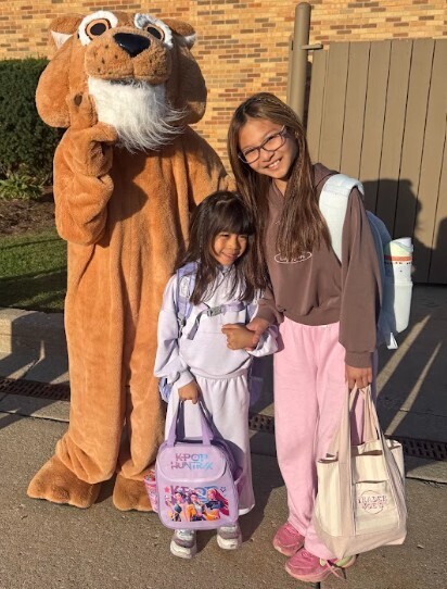photo of two students standing with Cody