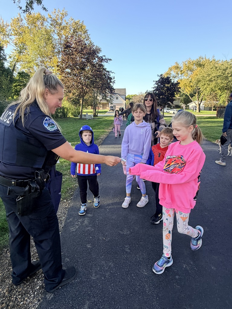 photo of students and Office Nowak walking and rolling to school
