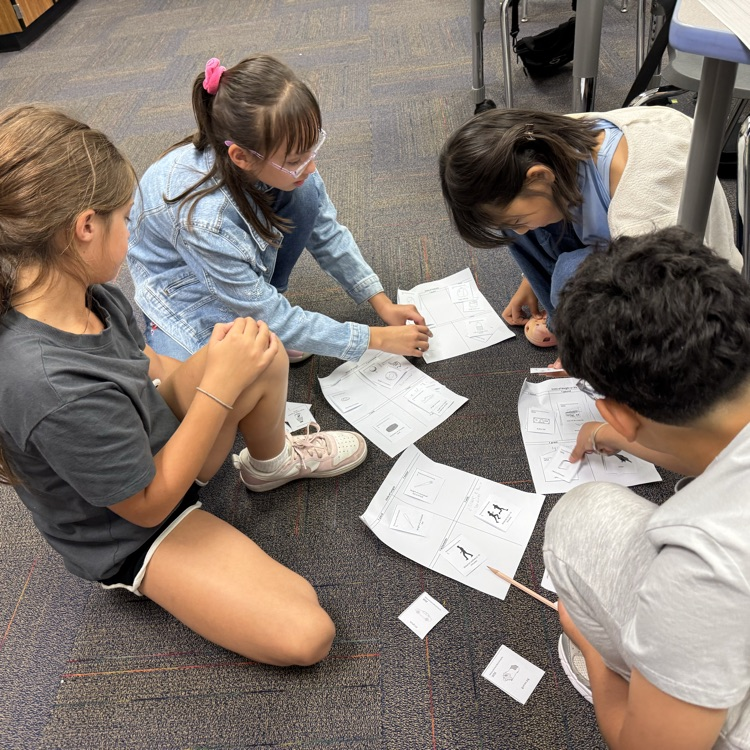 four students working to sort cards
