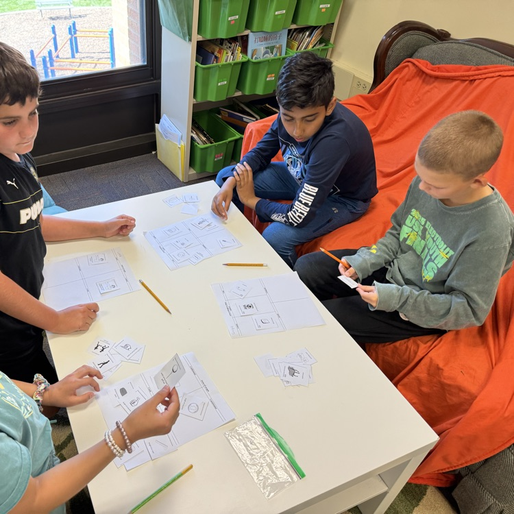 four students working to sort cards