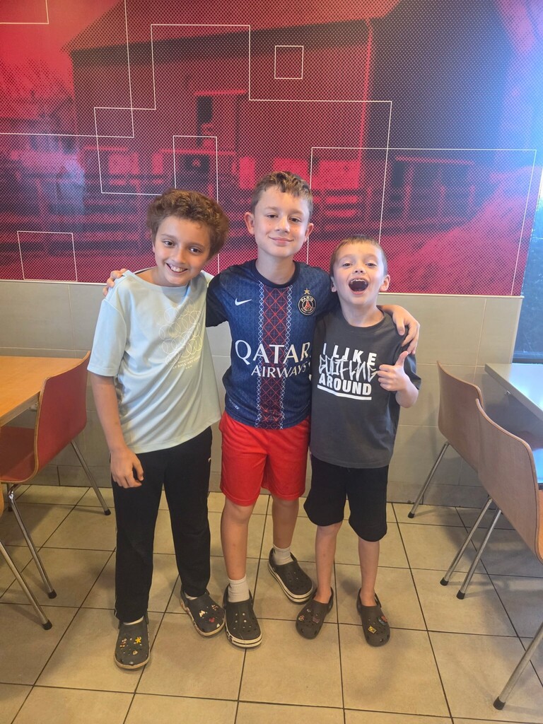 three boys smiling at McTeacher Night