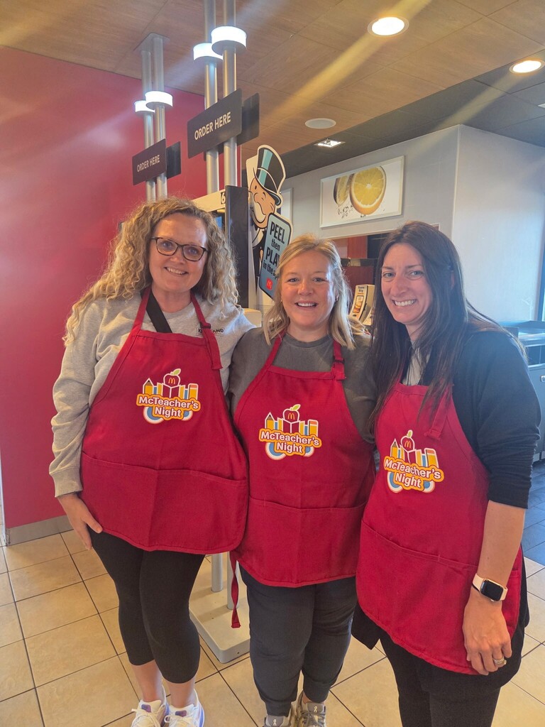 Mrs. Buckner, Mrs. Bonvillain, and Mrs. Imboden wearing McTeacher Night aprons