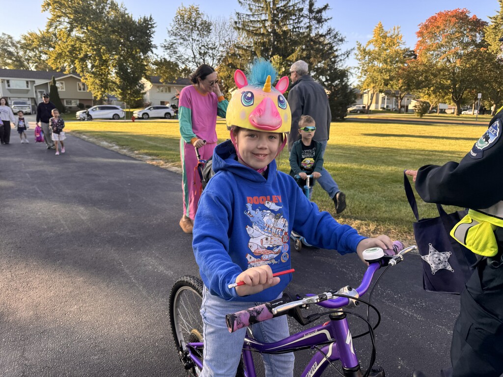a kid on a bike with a helment