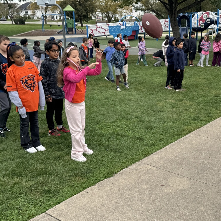 student throwing a football