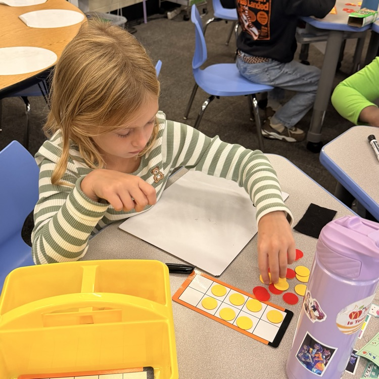 student using counter and a ten frame